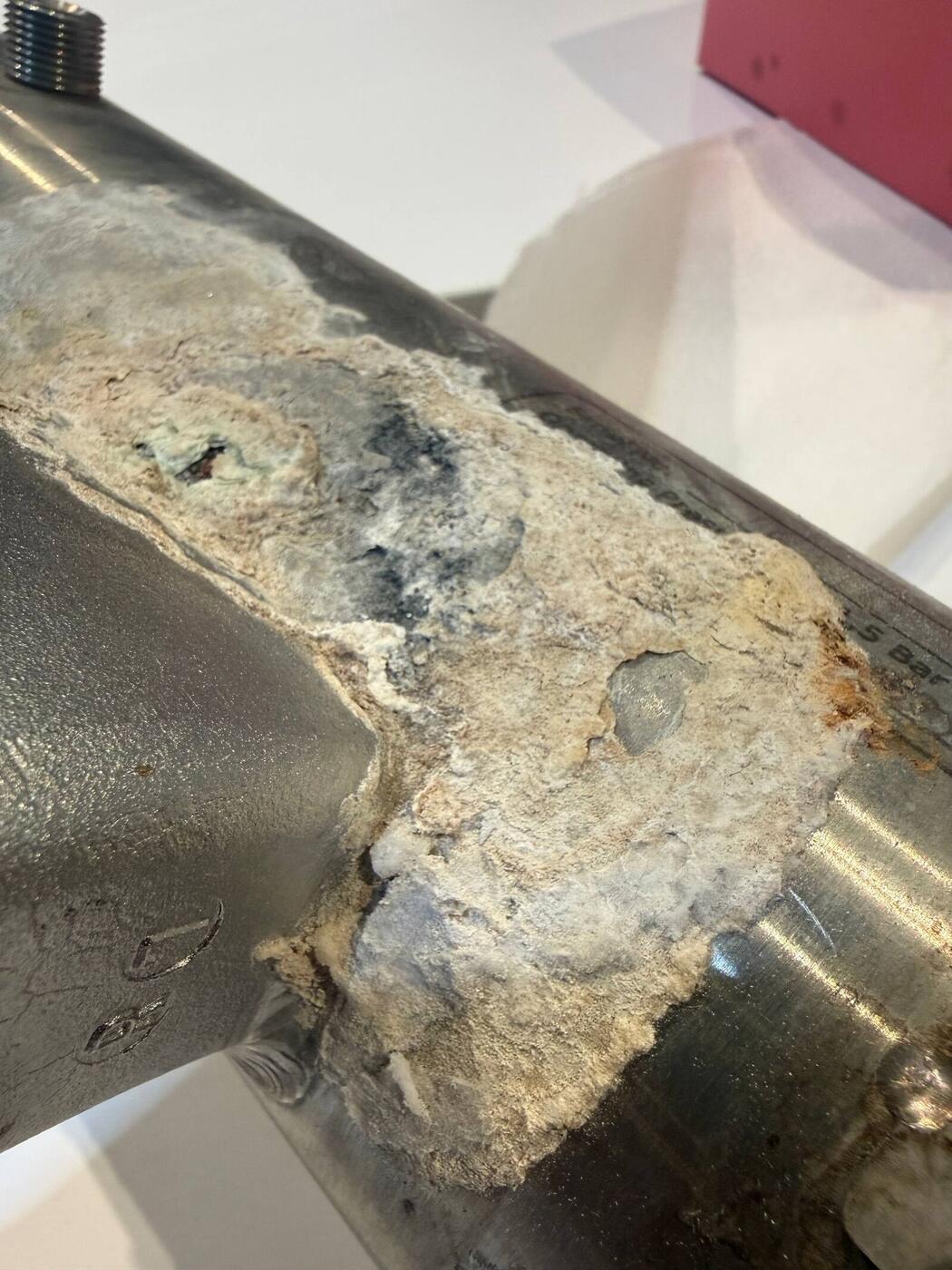 Scale buildup on an espresso machine component during La Marzocco factory training