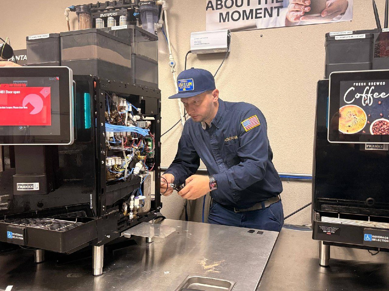 Andrew examining the inside of an open Franke A-Series coffee machine