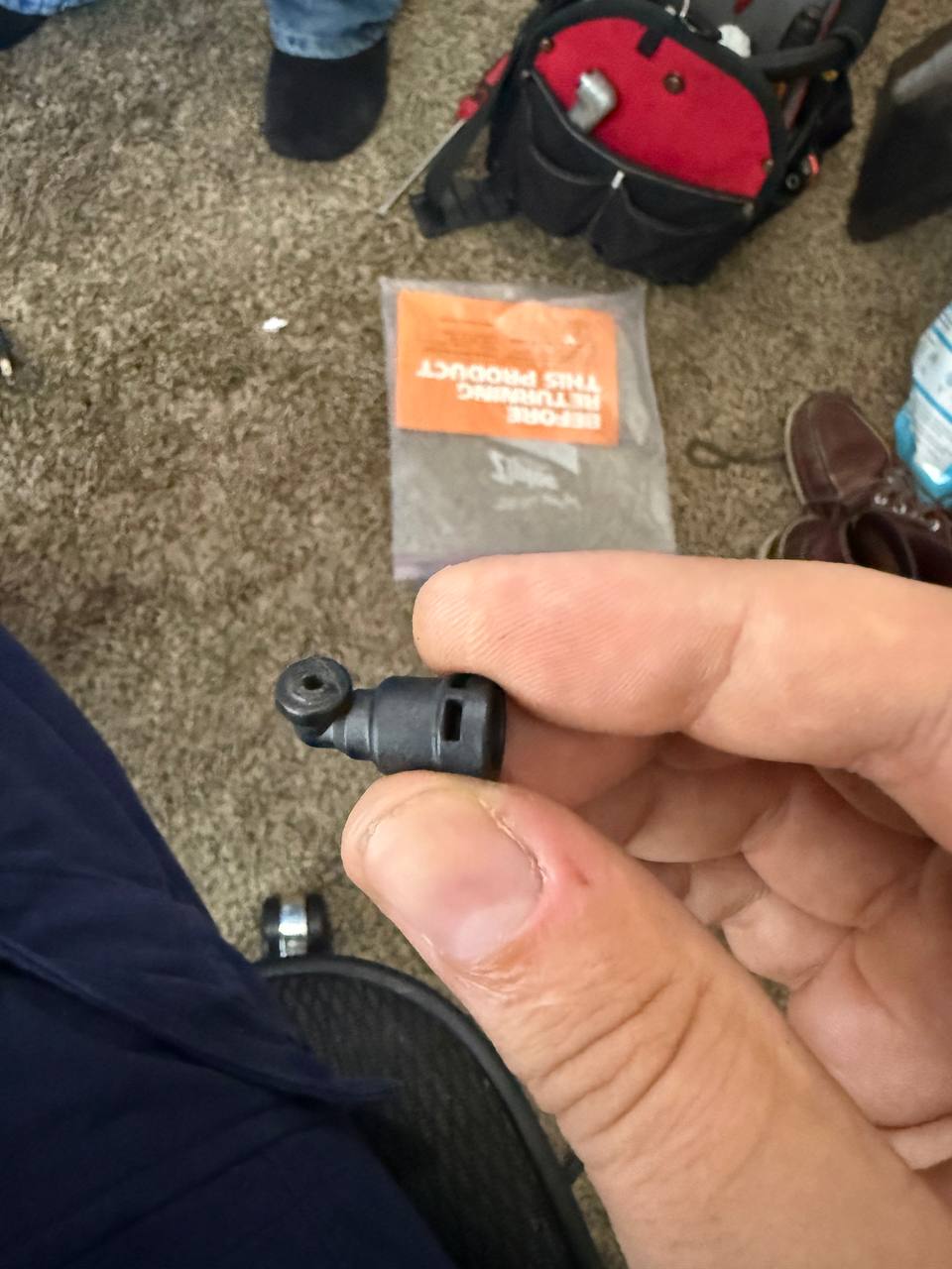 The broken plastic water-hose connector we removed and replaced.