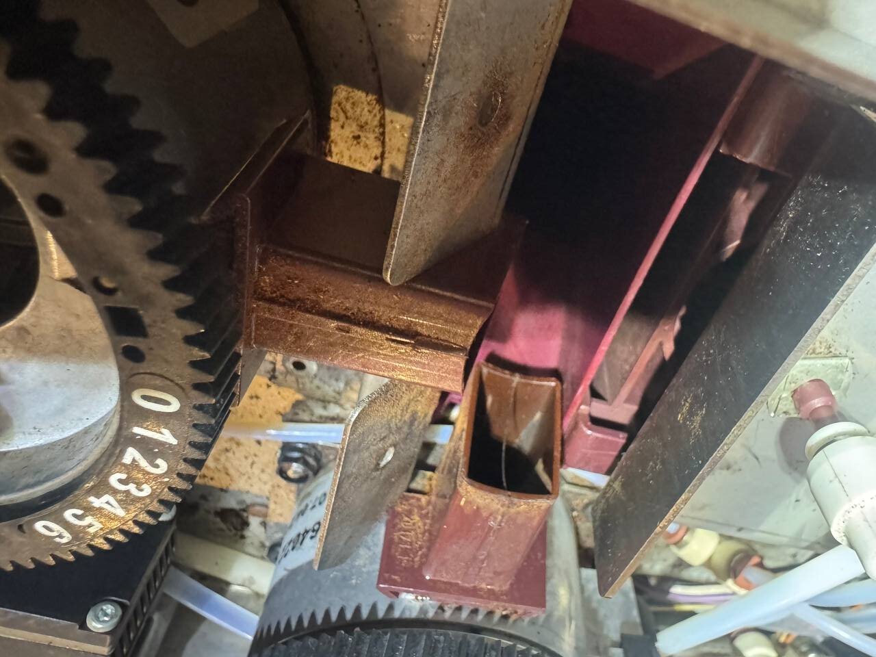 Grinder ring and chute with oxidized coffee oil before cleaning